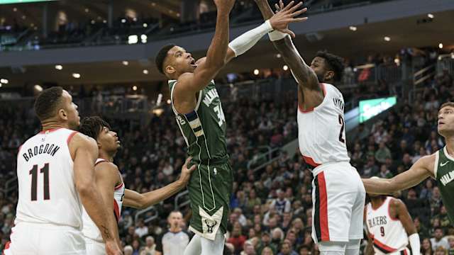 Milwaukee Bucks forward Giannis Antetokounmpo (34) shoots against Portland Trail Blazers center Deandre Ayton (2)